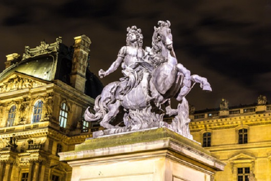 The Louvre at night in Paris Statue of Louis XVI